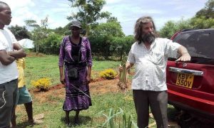 Photo of Roger explaining about planting Vetiver Grass to the youth, with Margaret Oluoch looking on from Newsletter April 2017