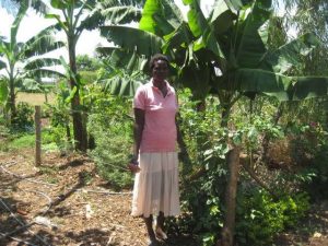 Yunis standing by the medicinal garden she teaches from 