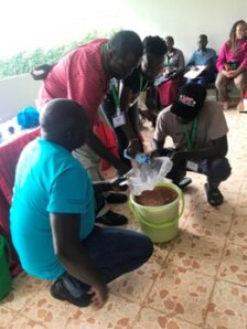 Photo of attendees cleaning water using Moringa seeds