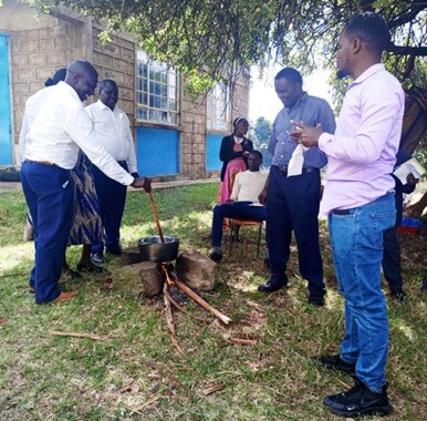 George teaching on making an ointment in a typical rural type setting